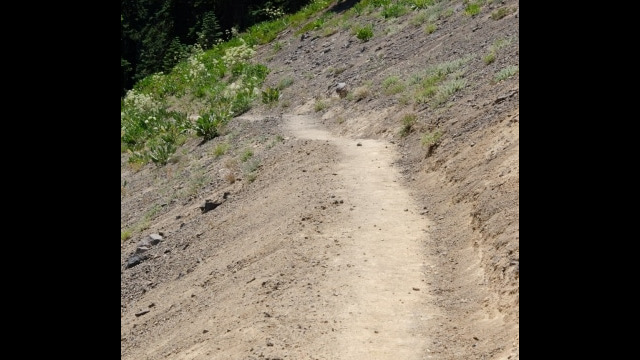Crossing exposed volcanic sand slope just before the volcanic plug Barker Pass