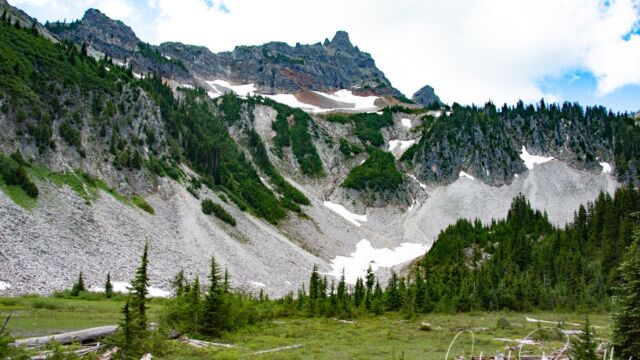 Continuing past the lake you reach the end of the official trail. There is a meadow, and rockfalls with a stream, and more flowers Snow Lake trail