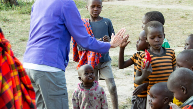 Greeting children in the Maasai village, with blessing to head (and then "high five") Greeting children in the Maasai village, with blessing to head (and then "high five")