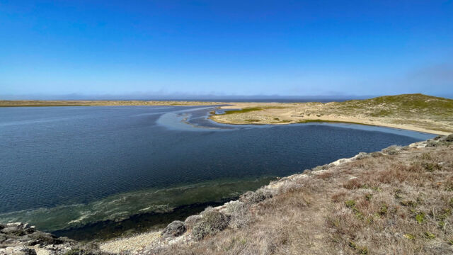 Looking west over the main lagoon, from a bluff. The path runes along the dunes at the far right Abbotts Lagoon. Looking west over the main lagoon, from a bluff. The path runes along the dunes at the far right